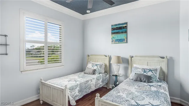 a bedroom with two beds and a window