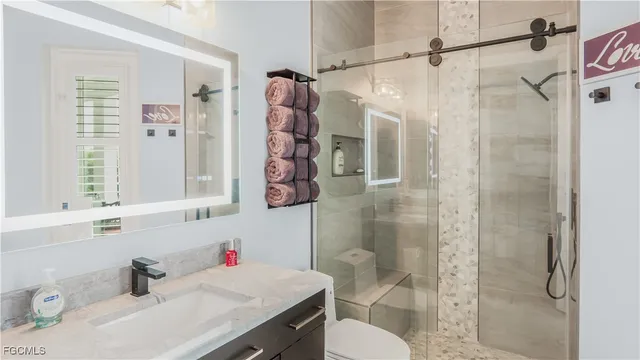 a bathroom with a sink toilet and shower