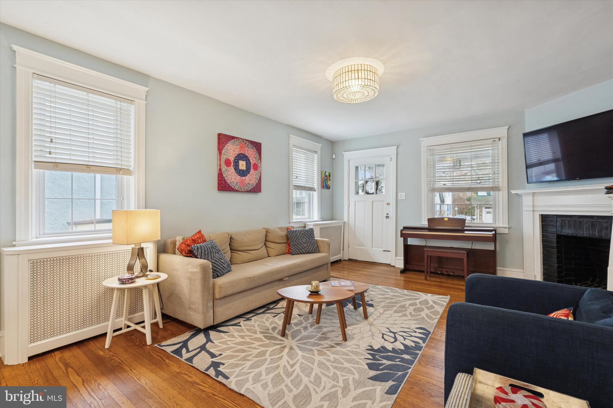 28 Chatham Road Ardmore, PA 19003 - Photo 4 of 32 a living room with furniture a fireplace and a flat screen tv