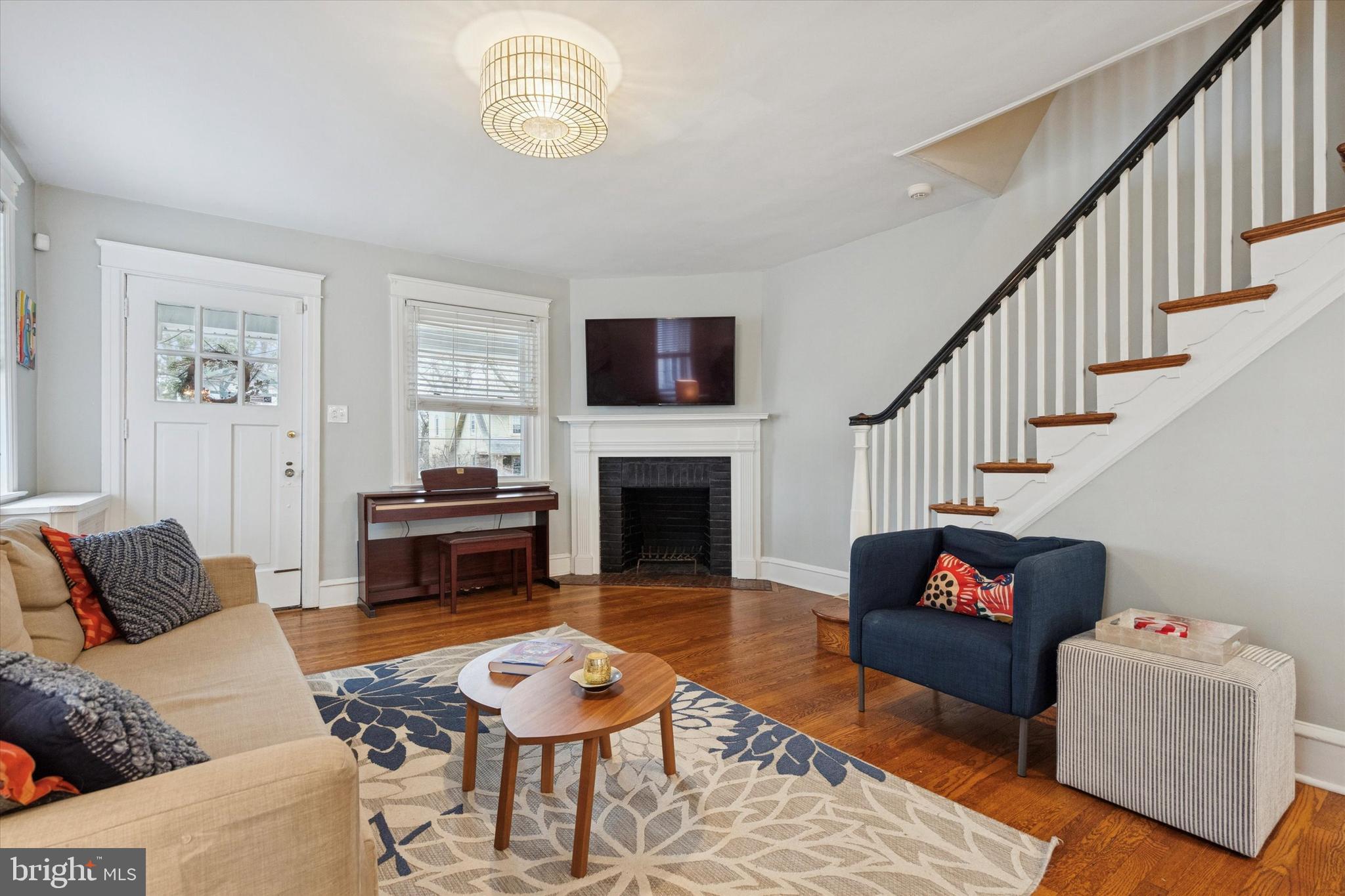 28 Chatham Road Ardmore, PA 19003 - Photo 5 of 32 a living room with furniture a flat screen tv and a fireplace