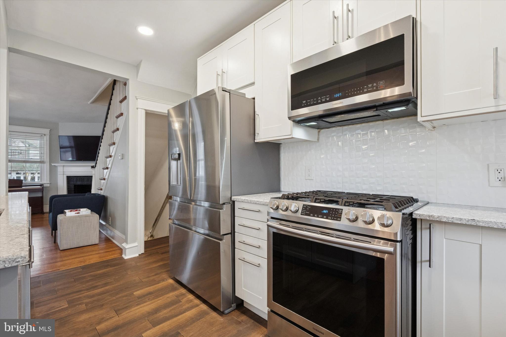 28 Chatham Road Ardmore, PA 19003 - Photo 9 of 32 a kitchen with stainless steel appliances a stove a microwave and cabinets