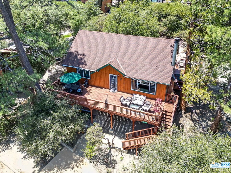 an aerial view of a house with yard and sitting area