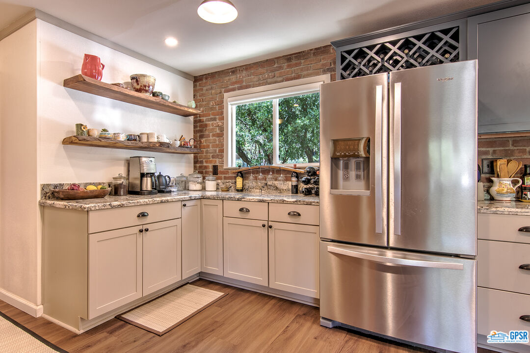 25527 Cedar Glen Drive Idyllwild, CA 92549 - Photo 12 of 69 a kitchen with stainless steel appliances a refrigerator sink and cabinets