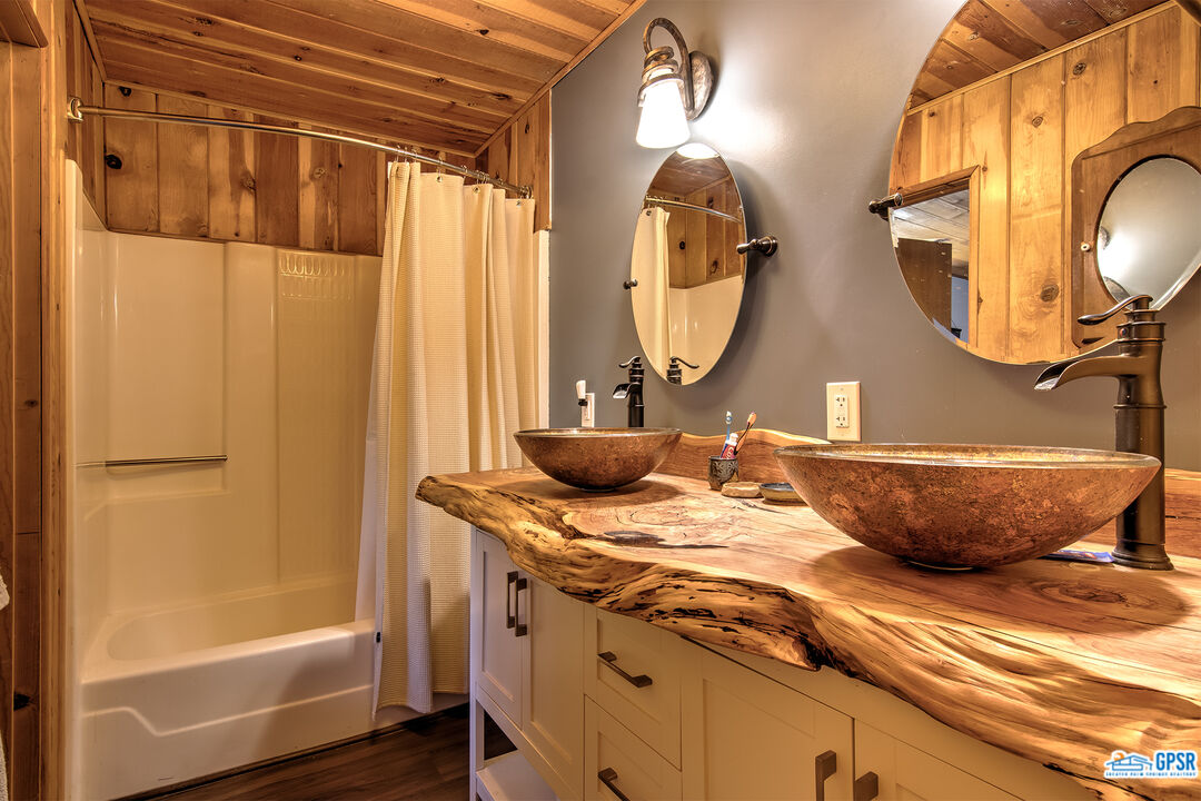 25527 Cedar Glen Drive Idyllwild, CA 92549 - Photo 22 of 69 a bathroom with a granite countertop sink and a mirror