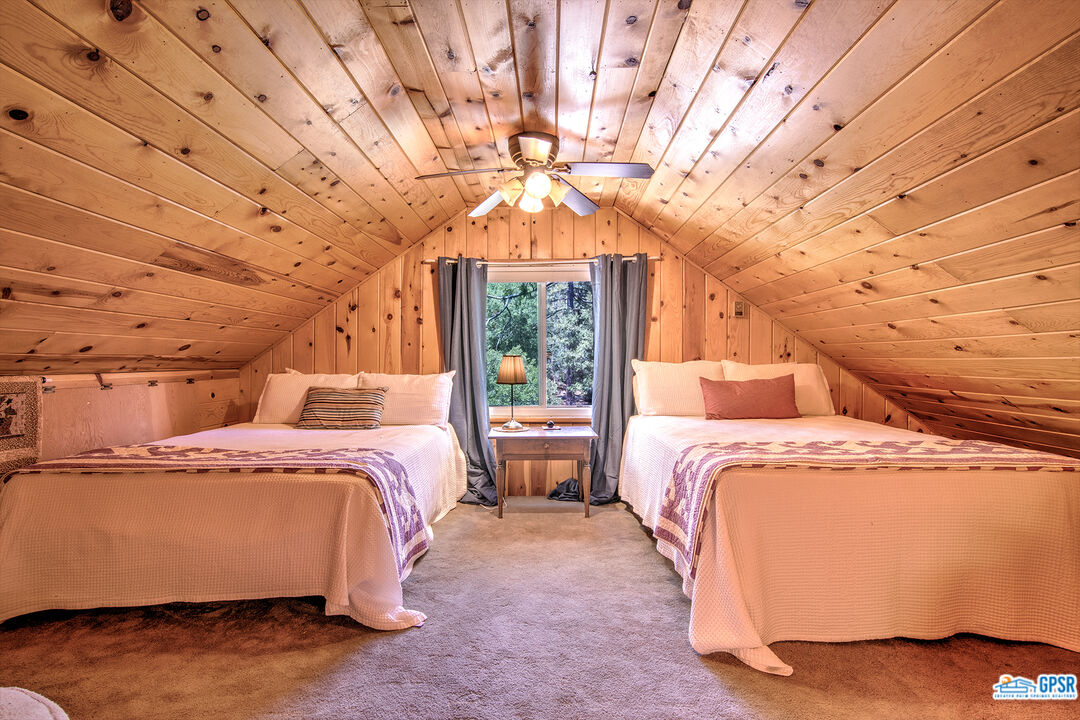 25527 Cedar Glen Drive Idyllwild, CA 92549 - Photo 25 of 69 a bed sitting in a bedroom next to a window