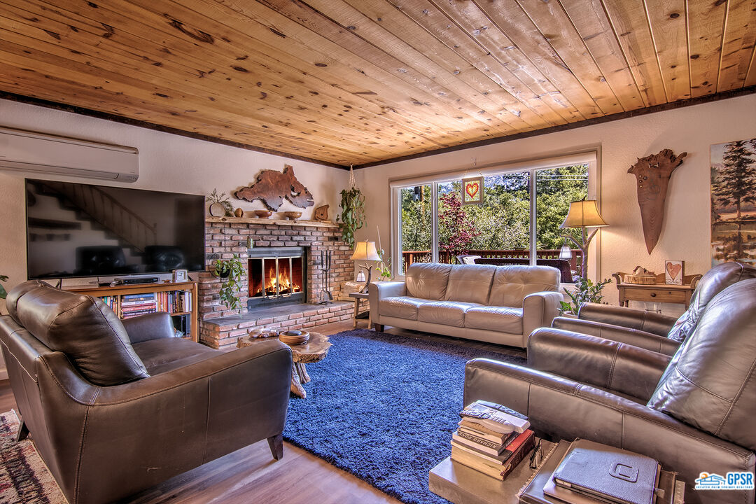 25527 Cedar Glen Drive Idyllwild, CA 92549 - Photo 4 of 69 a living room with furniture and a fireplace