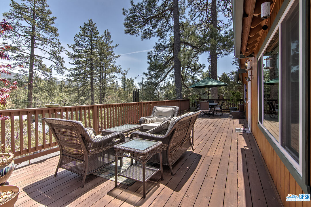25527 Cedar Glen Drive Idyllwild, CA 92549 - Photo 7 of 69 a view of balcony with wooden floor and outdoor seating