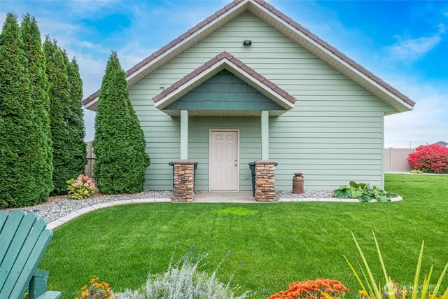 a front view of house with a garden and patio