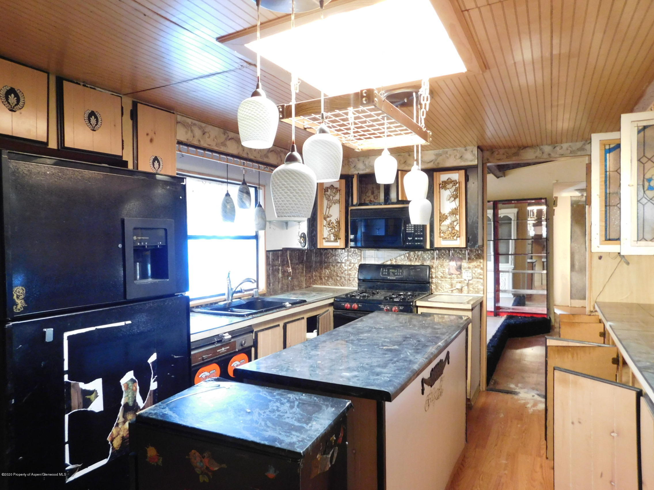 2235 Baker Drive Craig, CO 81625 - Photo 11 of 16 a kitchen with stainless steel appliances granite countertop a sink a stove and a wooden cabinets