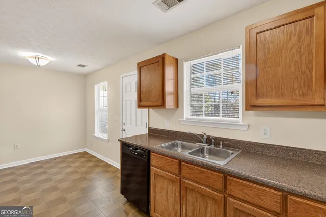 a kitchen with granite countertop a sink and a window