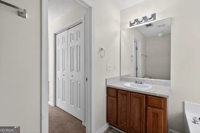 a bathroom with a mirror sink and toilet