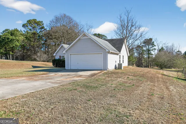 a view of a house with a yard and garage