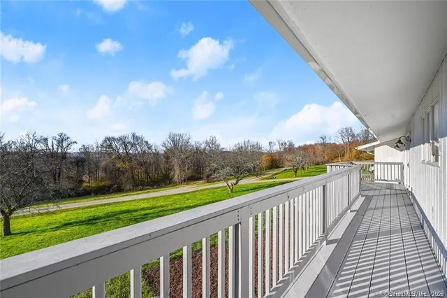 a view of a balcony with a yard