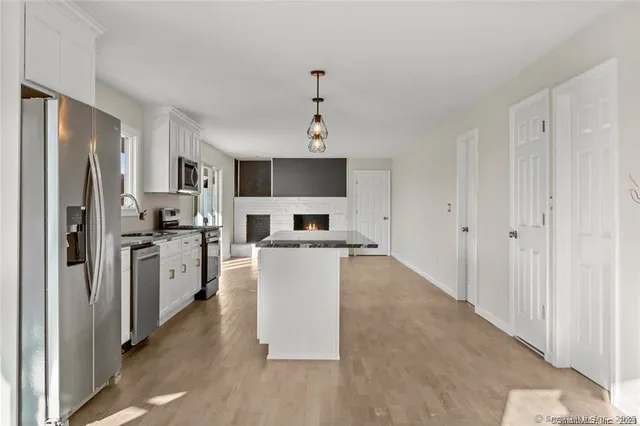 a view of an entryway with wooden floor
