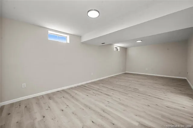 a view of an empty room with a fireplace and a window