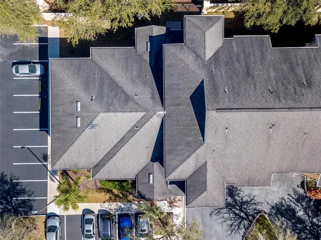 an aerial view of a house with a yard and fountain