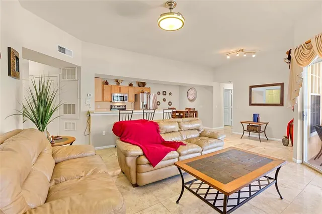 a living room with furniture a rug and a bookshelf