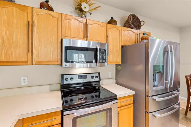 a kitchen with a refrigerator stove and microwave