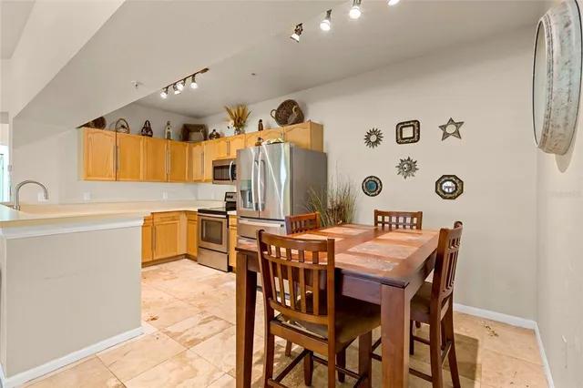 a kitchen with stainless steel appliances a sink and a refrigerator