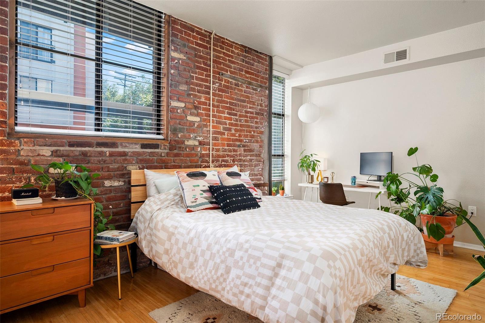 3225 Blake Street, Unit 4 Denver, CO 80205 - Photo 11 of 23 a large bed sitting in a bedroom next to a window