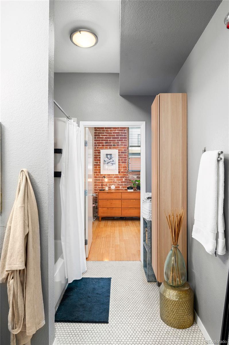 3225 Blake Street, Unit 4 Denver, CO 80205 - Photo 14 of 23 a view of walk in closet with clothes and shoes