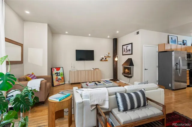 a living room with furniture a flat screen tv and a table