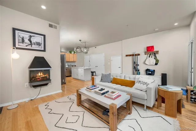 a kitchen with stainless steel appliances a table chairs refrigerator and microwave