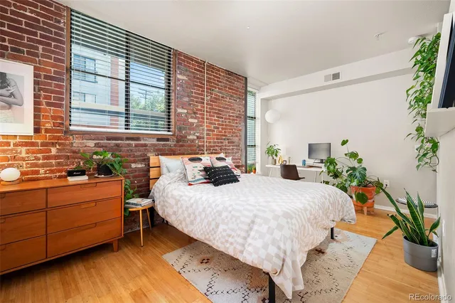 a large bed sitting in a bedroom next to a window