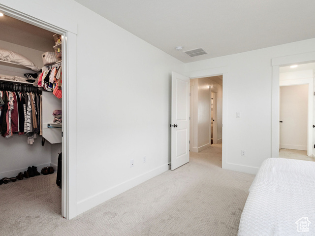 374 Ropelato Drive Nibley, UT 84321 - Photo 14 of 15 Unfurnished bedroom with carpet floors, a walk in closet, and a closet