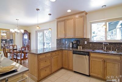 3700 Trinity Road Glen Ellen, CA 95442 - Photo 1 of 1 The kitchen looks into the dining area and out to the back gardens and fish pond.