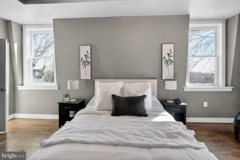 a bedroom with a bed and wooden floor