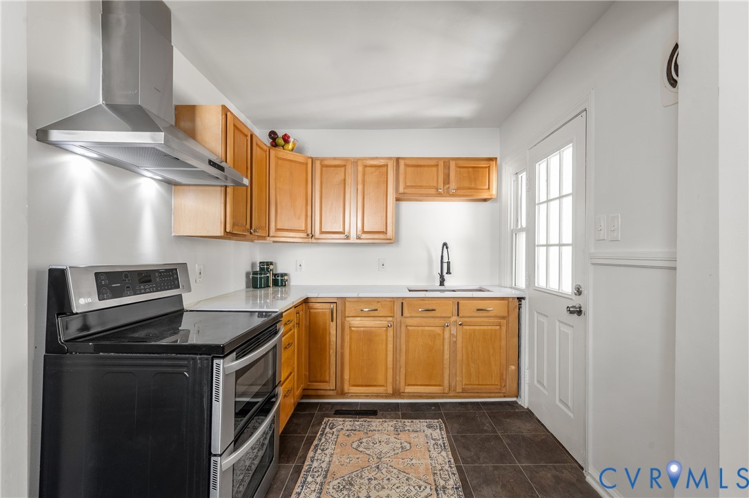 3406 Meadowbridge Road Richmond, VA 23222 - Photo 5 of 12 Kitchen featuring wood cabinetry, white countertop