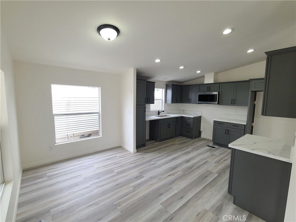 840 East Foothill Boulevard, Unit 64 Azusa, CA 91702 - Photo 12 of 25 a view of kitchen with wooden floor and electronic appliances