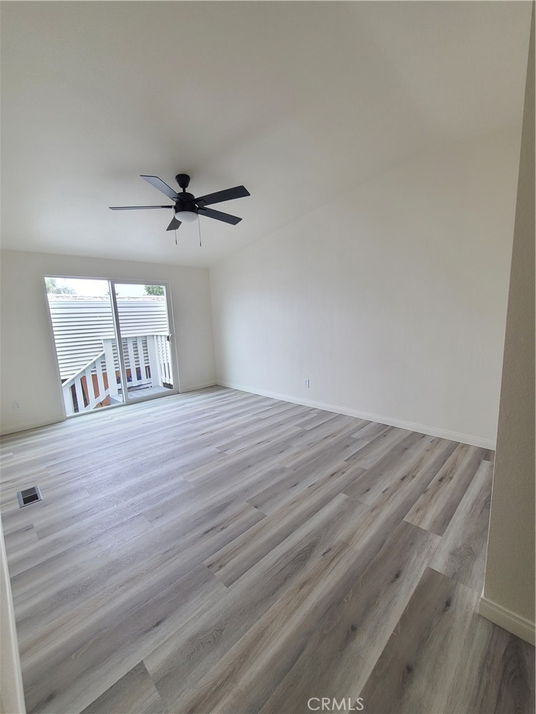 840 East Foothill Boulevard, Unit 64 Azusa, CA 91702 - Photo 15 of 25 a view of a livingroom with a ceiling fan and wooden floor