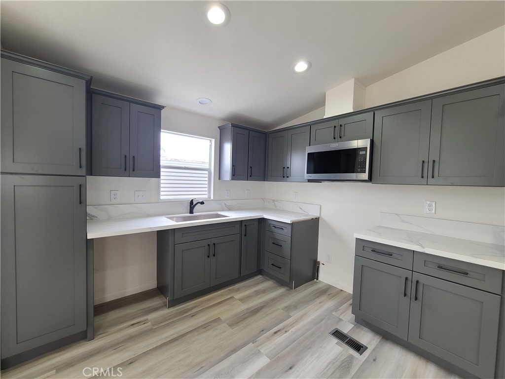 840 East Foothill Boulevard, Unit 64 Azusa, CA 91702 - Photo 6 of 25 a kitchen with a sink cabinets and stainless steel appliances