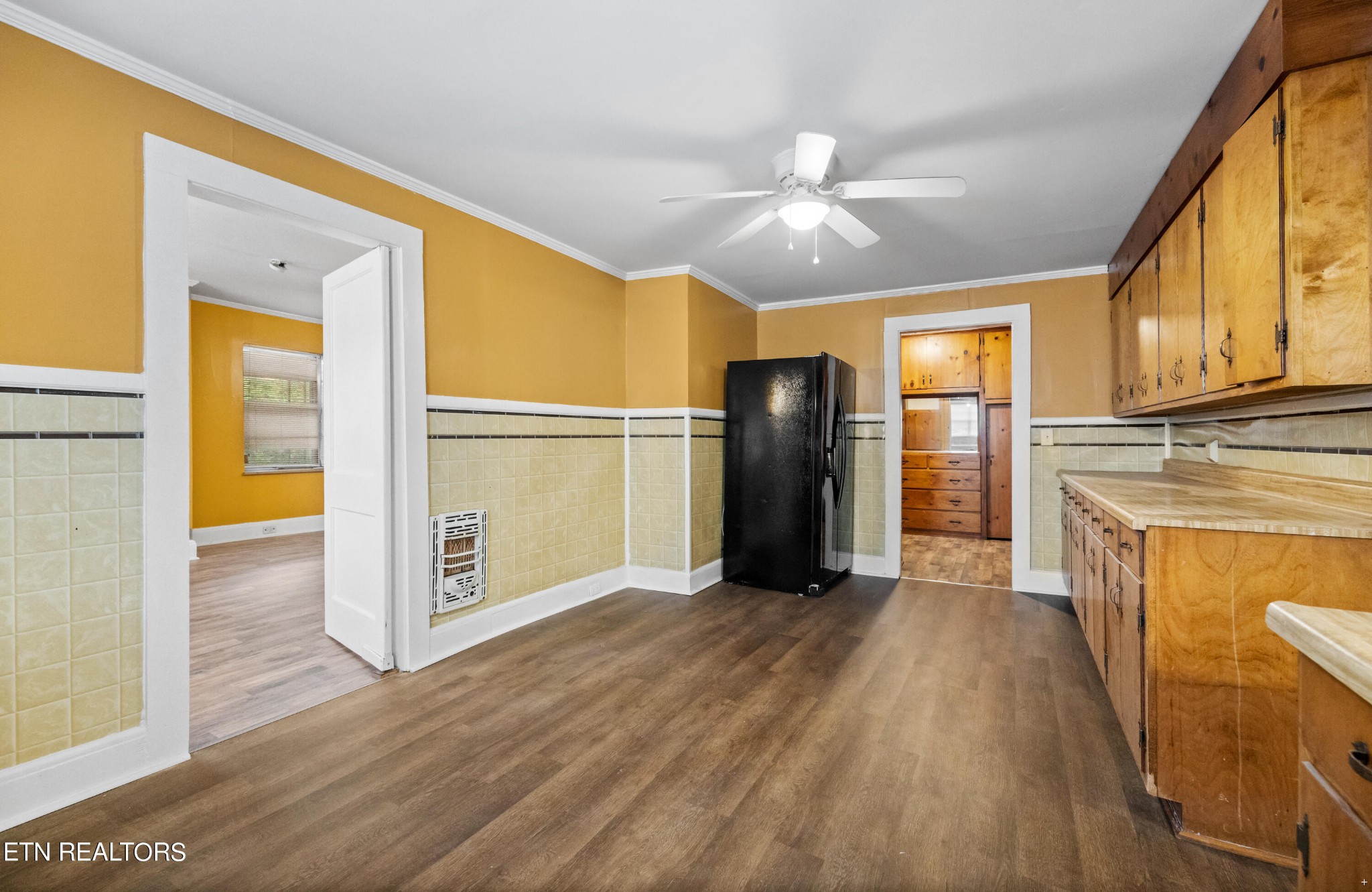 738 South Jackson Street Athens, TN 37303 - Photo 14 of 25 a view of a kitchen with a stove wooden cabinets and wooden floor