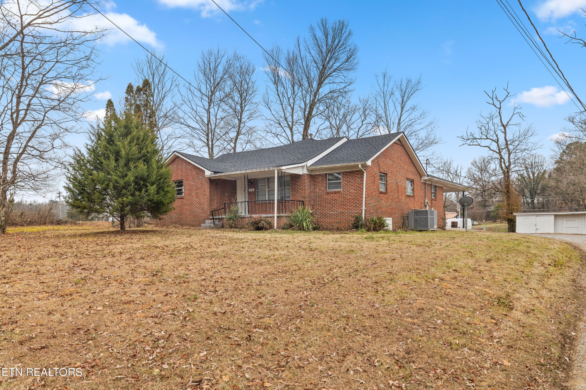 738 South Jackson Street Athens, TN 37303 - Photo 2 of 25 a front view of house with yard and trees around