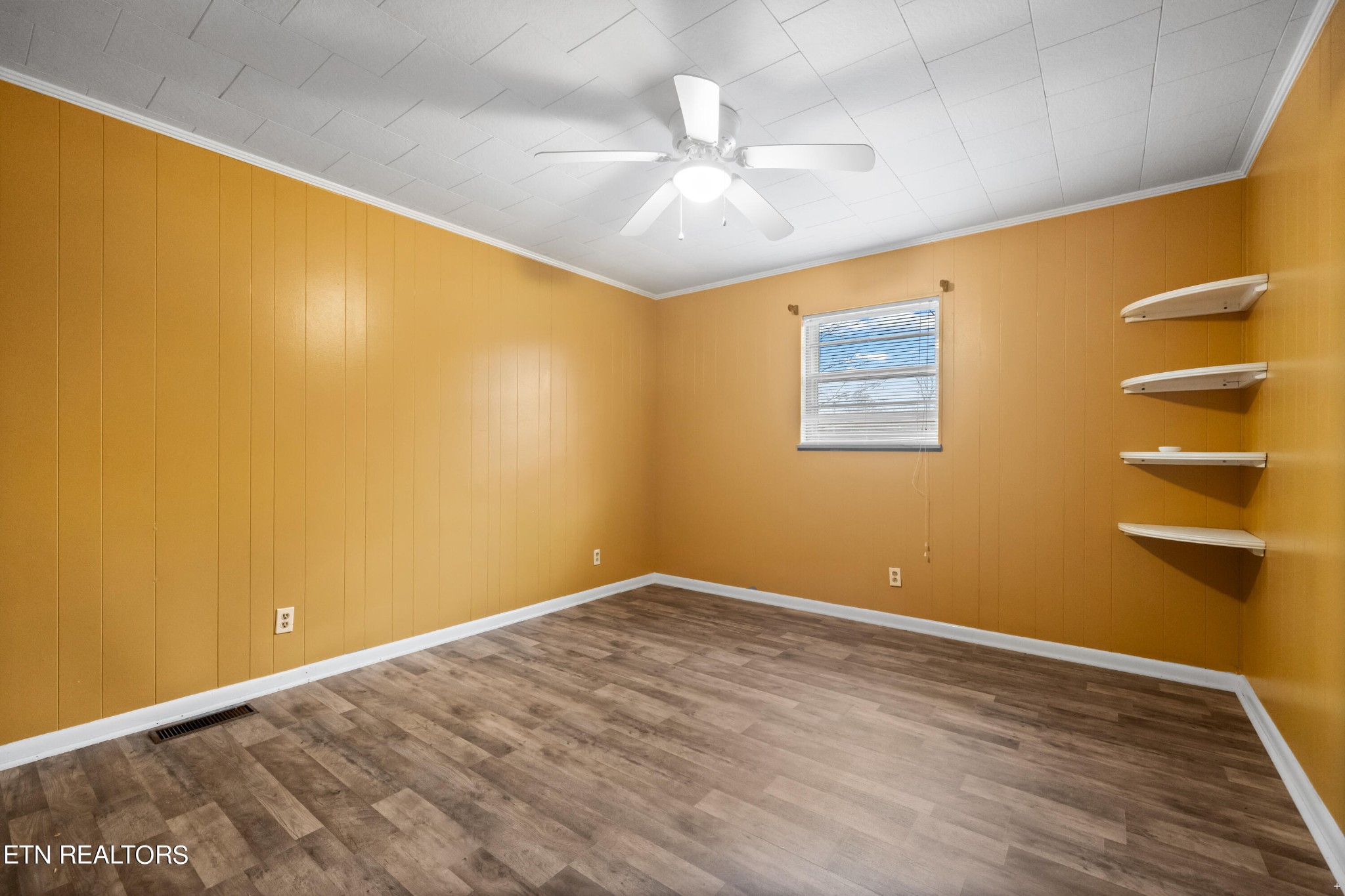 738 South Jackson Street Athens, TN 37303 - Photo 6 of 25 a view of an empty room with wooden floor and a window