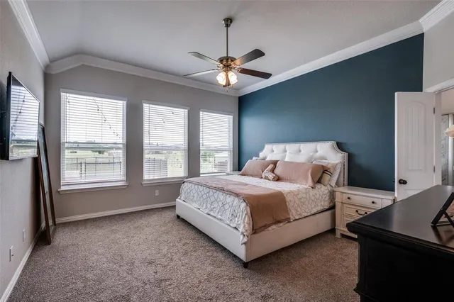 a spacious bedroom with a bed and a chandelier