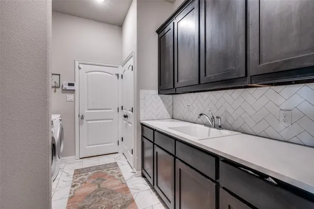 a kitchen with a sink and a refrigerator