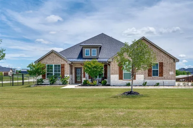 a front view of a house with a yard