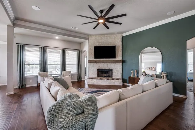 a living room with furniture fireplace and a large window