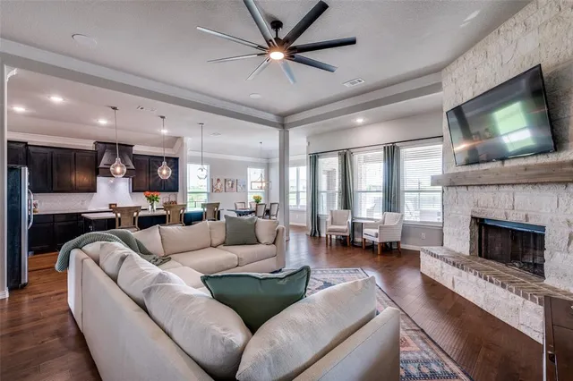 a living room with furniture a fireplace and a flat screen tv