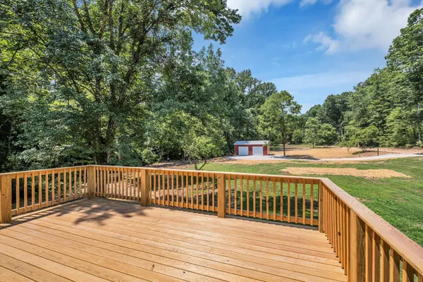 a balcony with wooden floor and fence