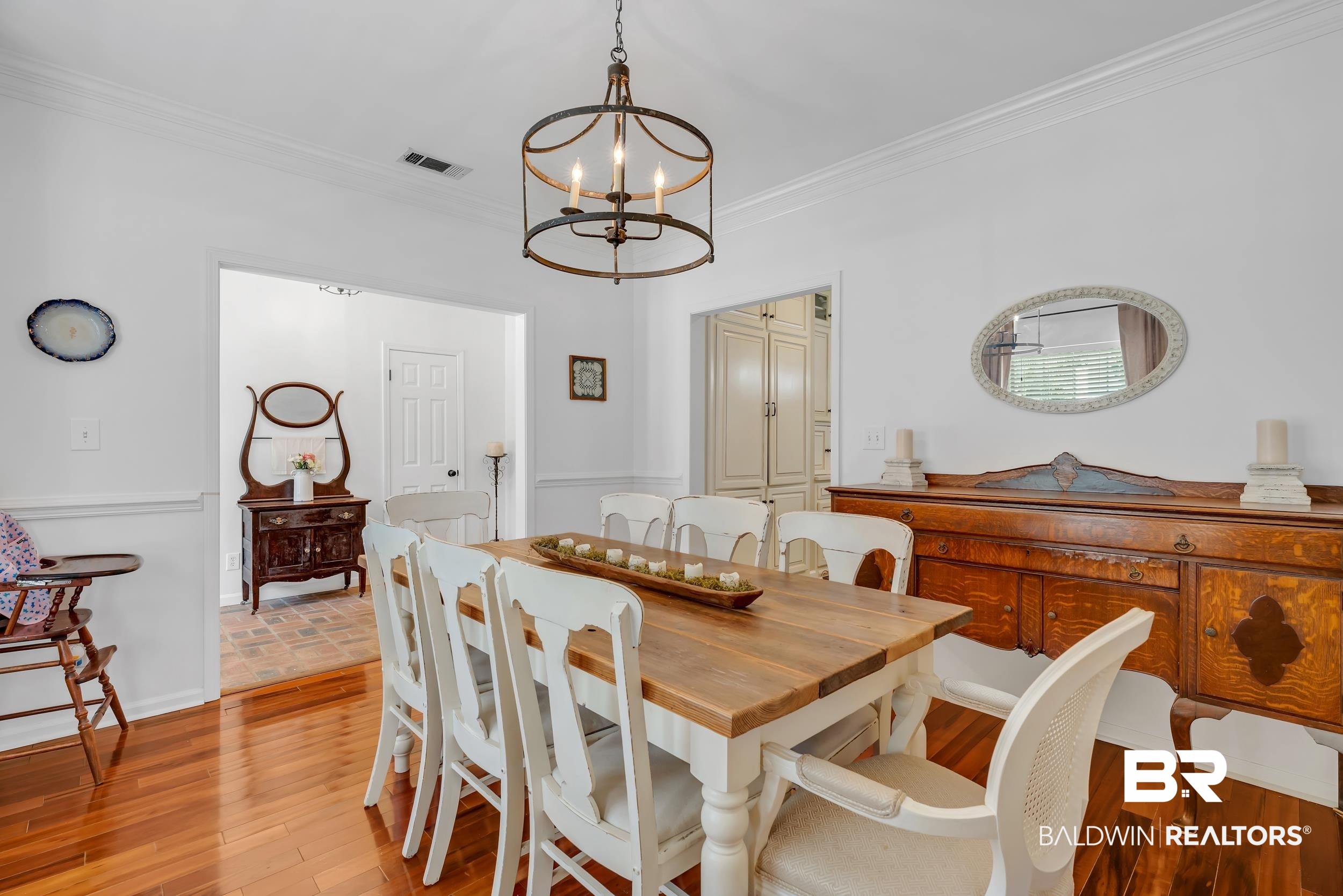 2 Navy Lane Daphne, AL 36527 - Photo 12 of 28 Dining room with ornamental molding, light wood-style flooring, and a chandelier