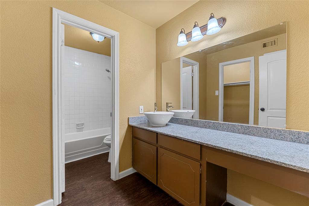 5516 Boca Raton Boulevard, Unit 310 Fort Worth, TX 76112 - Photo 13 of 19 a bathroom with a granite countertop sink mirror and a bathtub