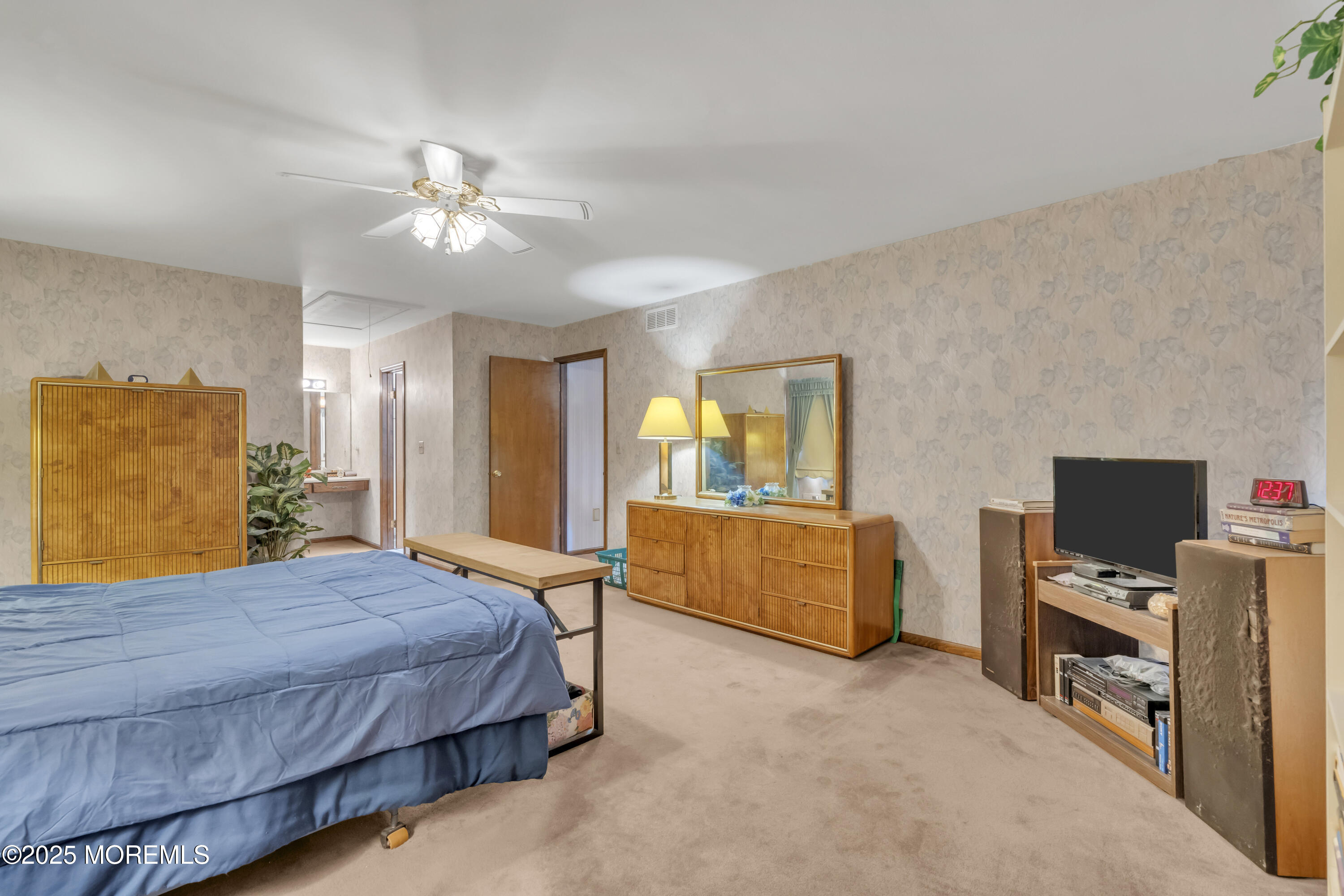24 Laird Road Middletown, NJ 07748 - Photo 24 of 45 a bedroom with a bed and a flat screen television