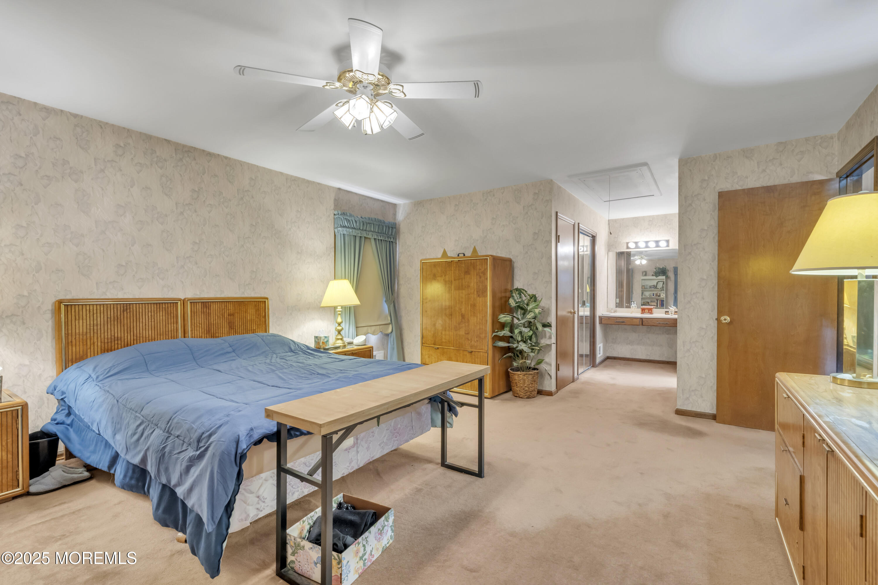24 Laird Road Middletown, NJ 07748 - Photo 26 of 45 a bed room with a bed and a chandelier