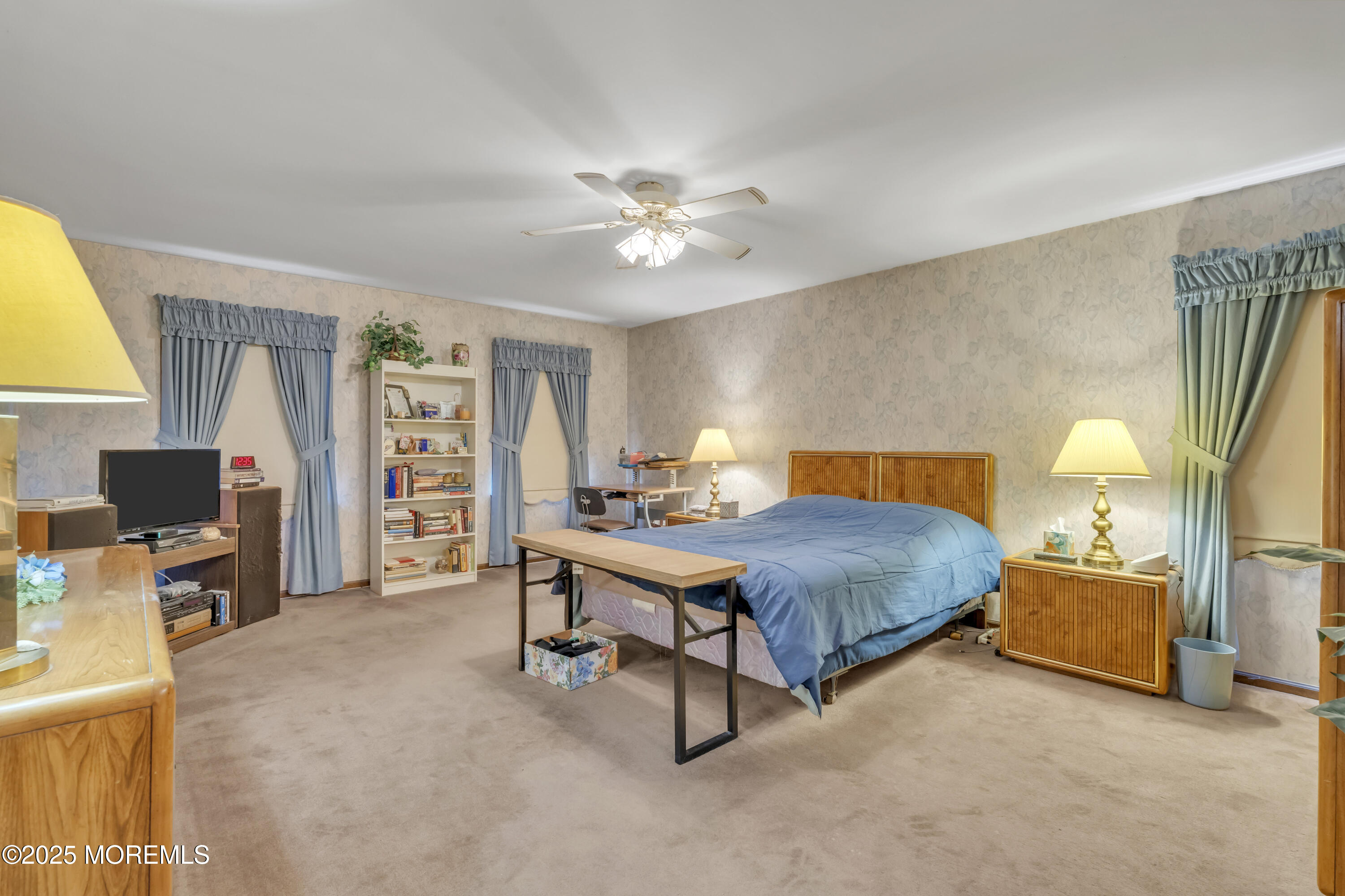 24 Laird Road Middletown, NJ 07748 - Photo 27 of 45 a bedroom with furniture and a chandelier