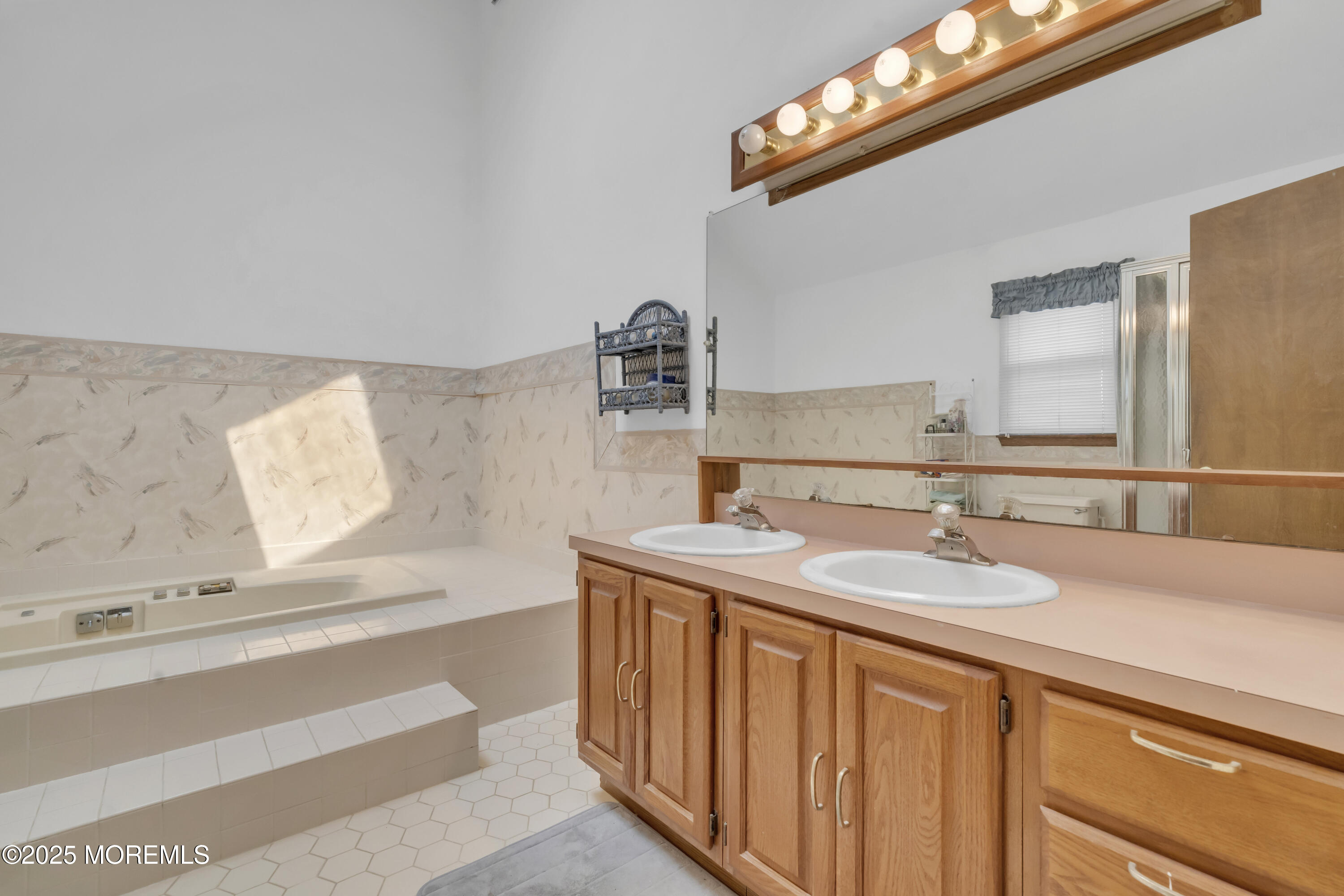24 Laird Road Middletown, NJ 07748 - Photo 29 of 45 a bathroom with a sink and a mirror